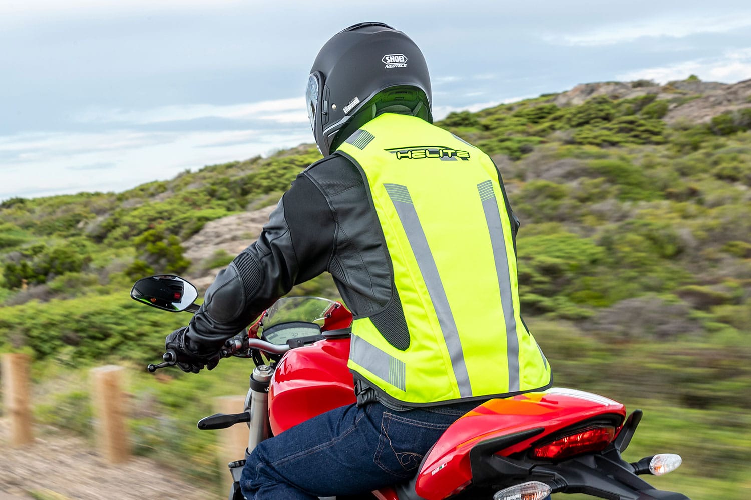 Biker wearing a Turtle 2 safety vest on motorbike rear view Hi Vis